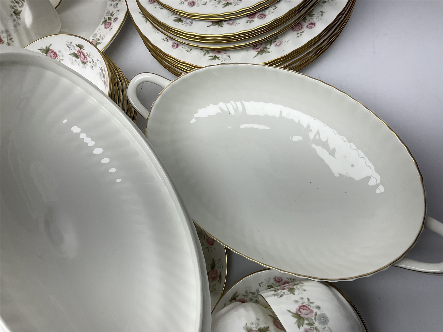 Minton Spring Bouquet pattern dinner and tea service, comprising dinner plates, twin handled tureens with covers, meat platter, teapot, milk jug, sugar bowl with cover, tea cups and saucers, bowls, cake plate, side plates, dessert plates, etc all with printed mark beneath (82)