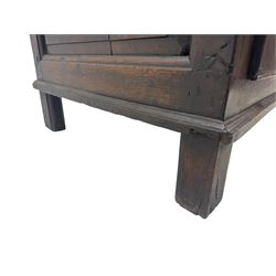 Early 18th century oak mule chest, hinged rectangular top above three recessed panels and two drawers, each fitted with brass drop handles, open interior fitted with candle box compartment, raised on square supports
