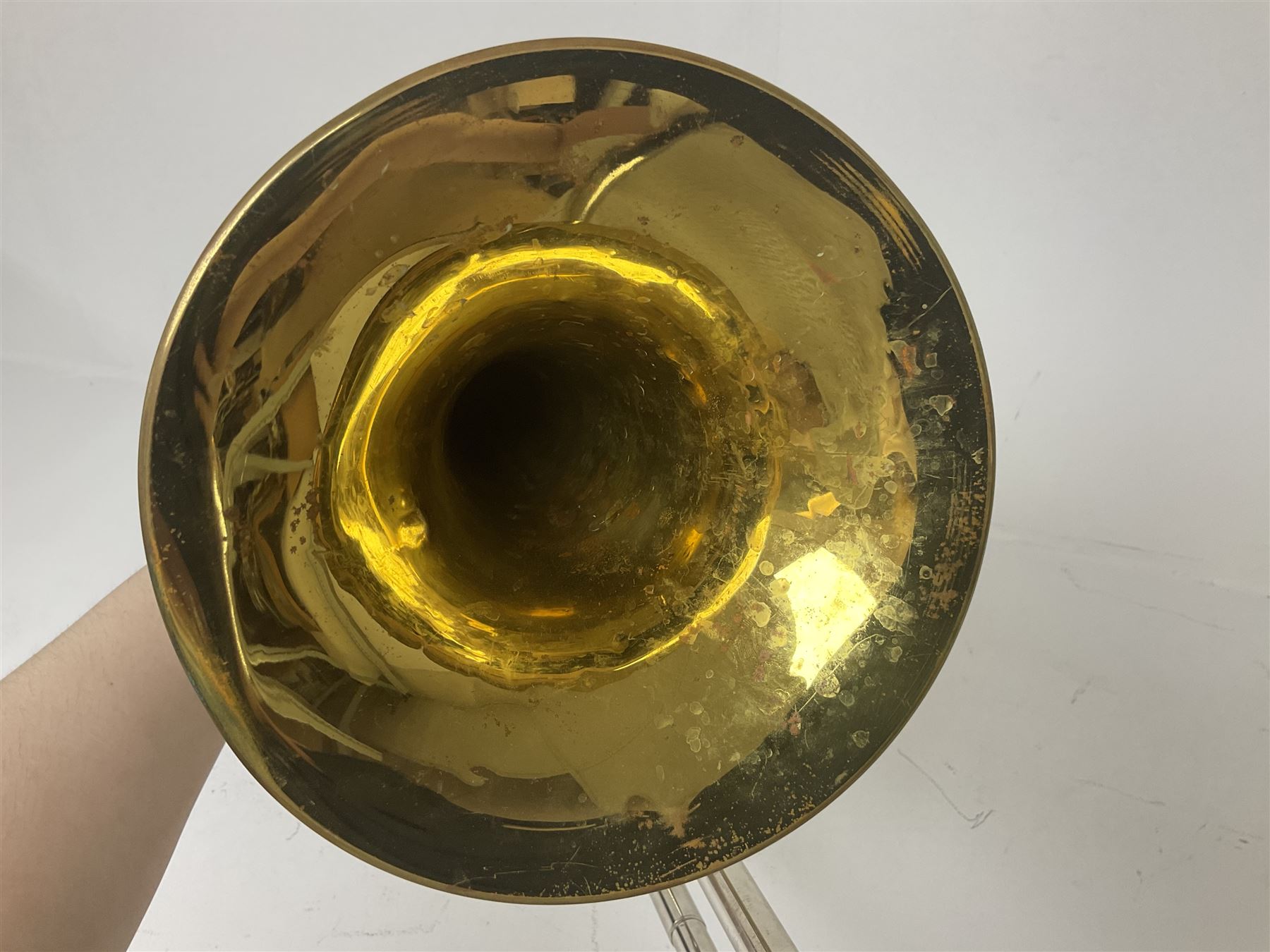 Three brass trombones comprising Elkhart Ind. USA 'CONN' model no.72H; Besson 'Concord'; and Selmer Distributed 'Lincoln'; two in carrying cases; and German B & M 'Champion' brass trumpet (4)