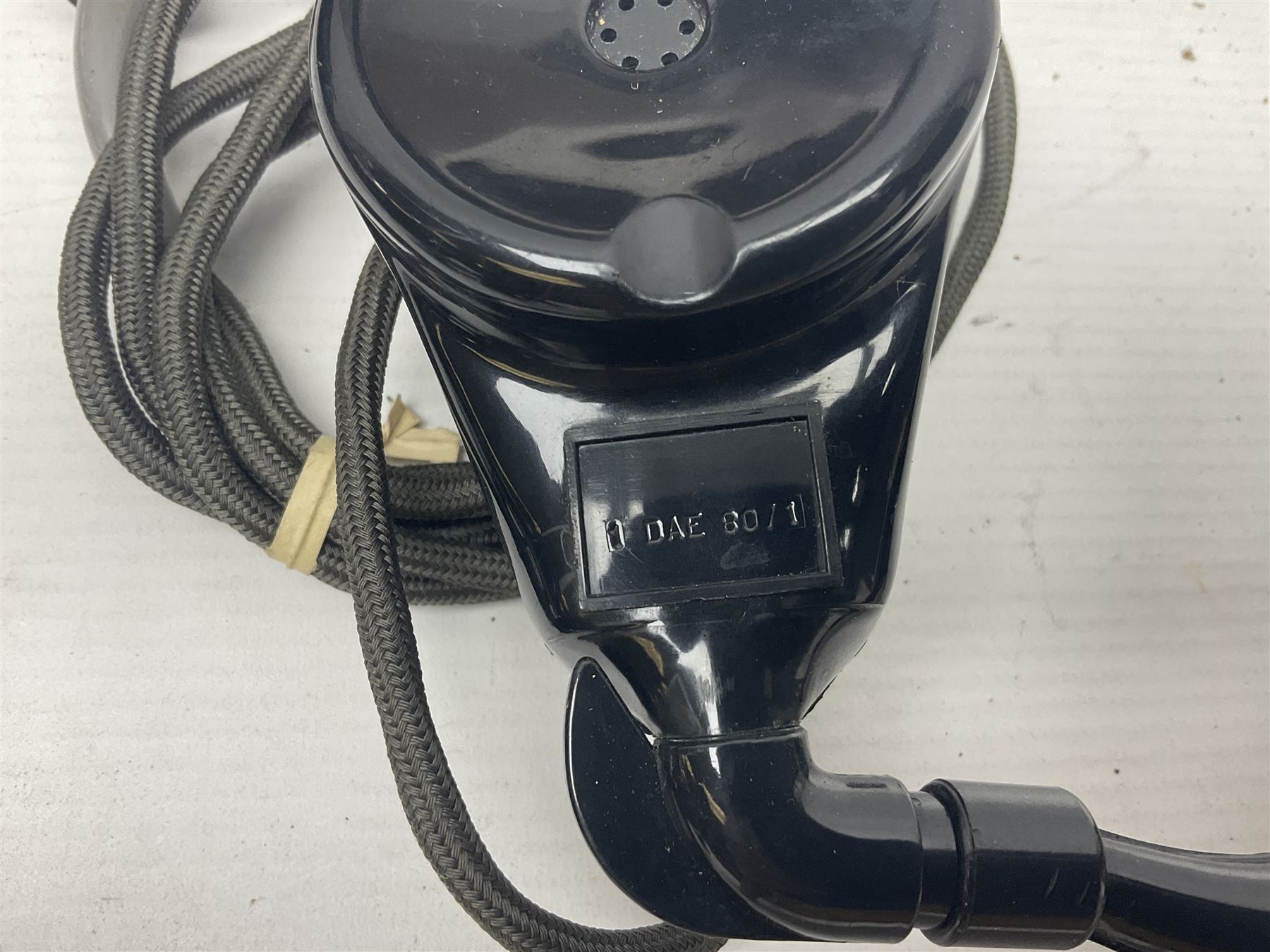 Collection of phone headsets, including GPO bakelite examples, together with other telephone parts 