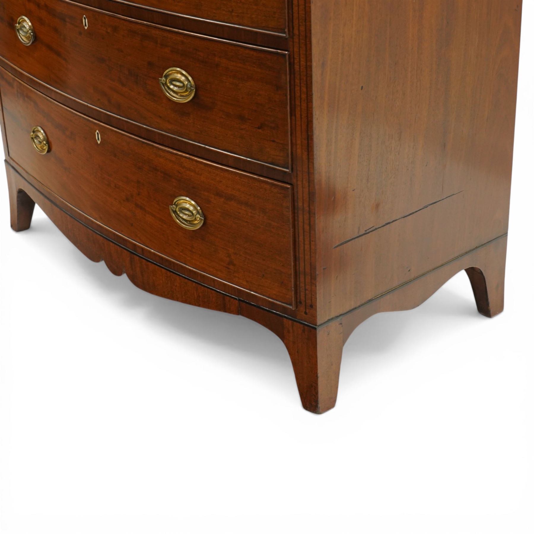 Early 19th century Regency mahogany bow-front chest, with banded caddy top and ebony stringing, fitted with two short over three long cockbeaded drawers, with oval brass handles, shaped apron and splayed bracket feet