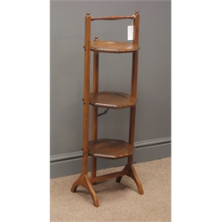  Early 20th century oak three tier folding cake stand, two arched supports, W30cm, H90cm  