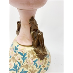 A late 19th century Aesthetic Movement Old Hall vase designed by Christopher Dresser, the flared body decorated with stylised flowering vines, leading to a tapering neck and flared rim with twin figural handles (one s/d), and raised upon a circular footed base, with printed mark beneath, H35cm. 