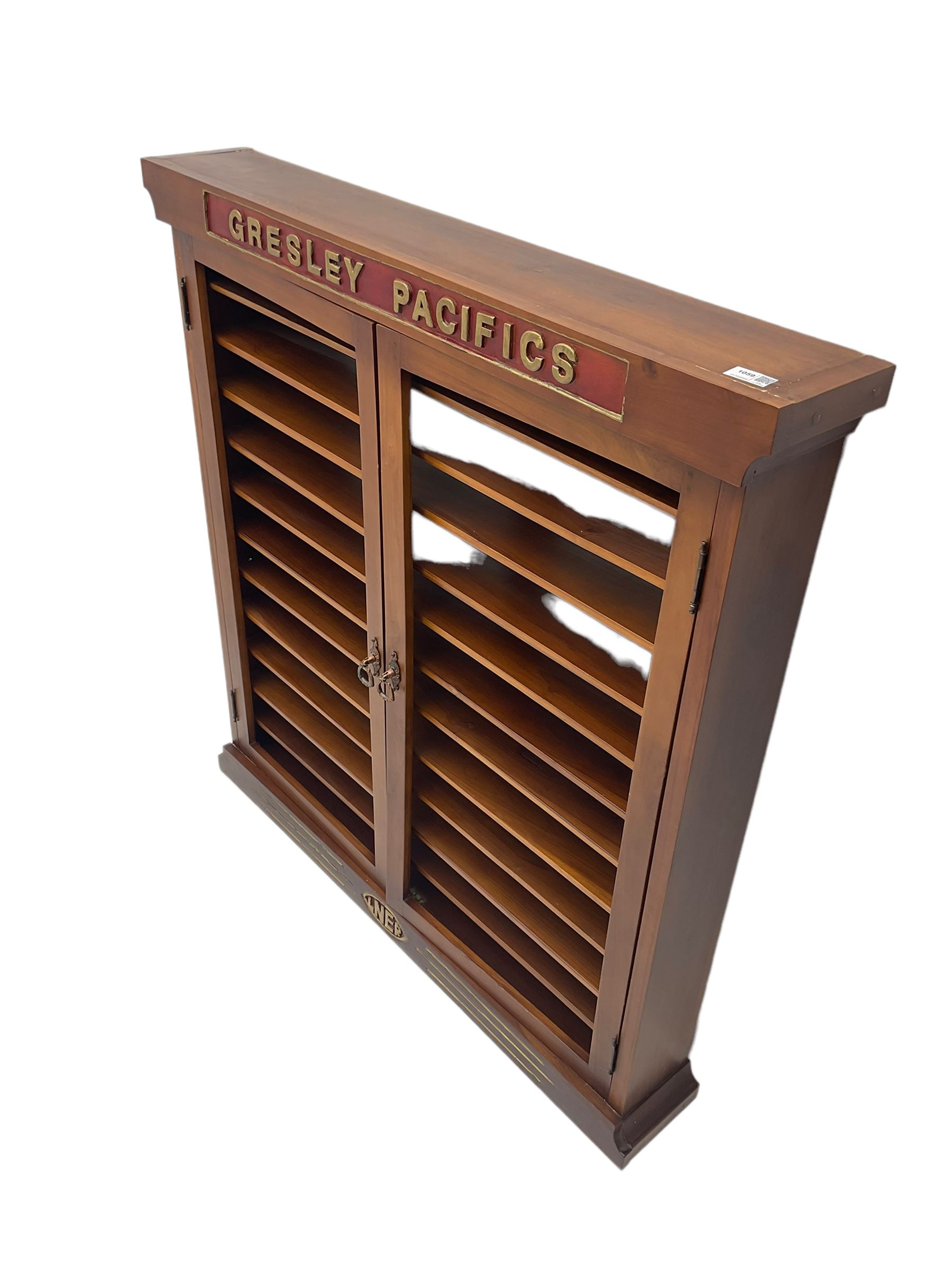 Modern hardwood display cabinet for model railway locomotives inscribed 'Gresley Pacifics' to the frieze and 'LNER' to the bottom rail; with mirrored back and ten loose fitting shelves enclosed by a pair of unglazed doors L101cm H108cm D16cm