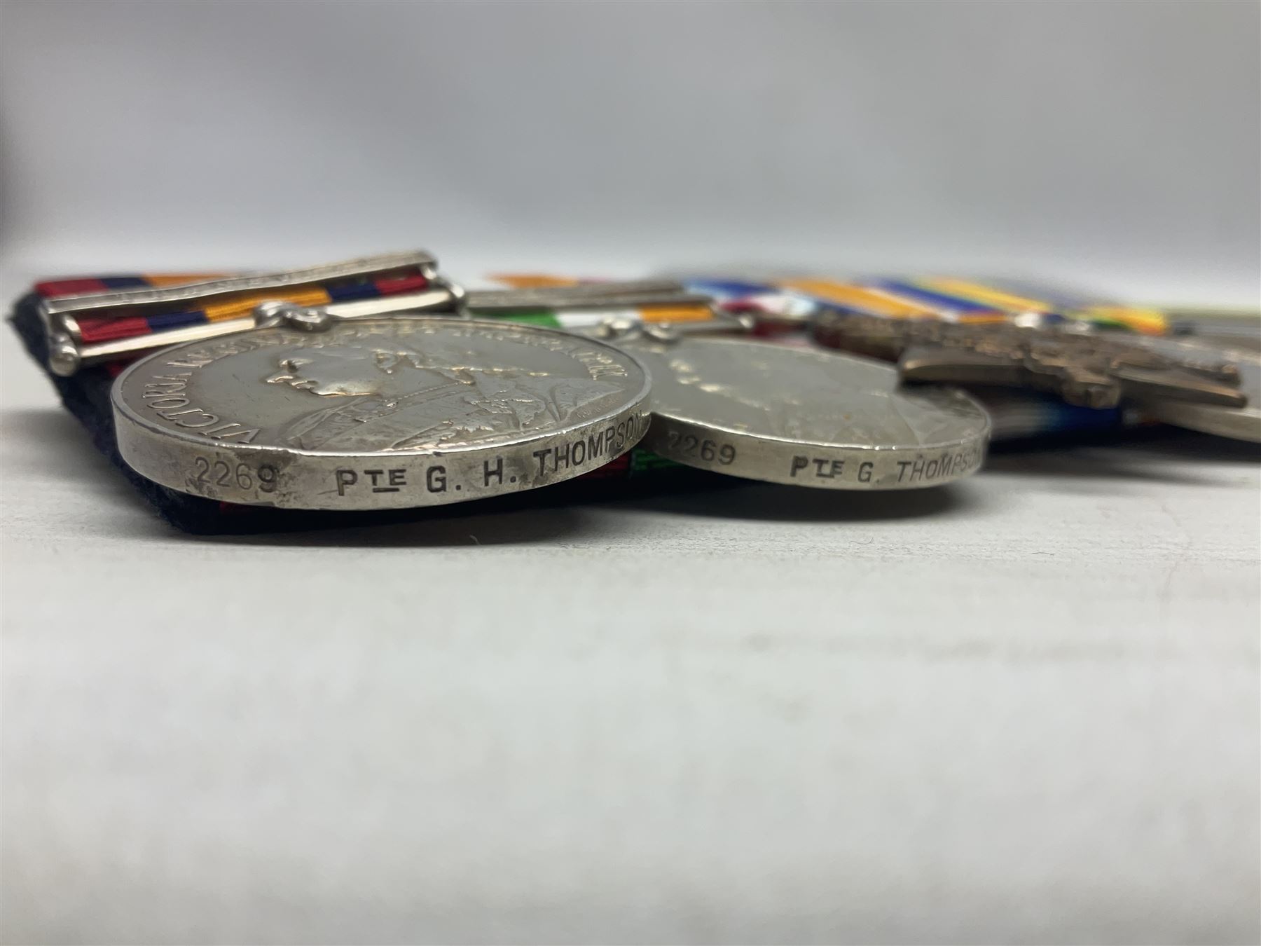 Boer War/WW1 group of five medals comprising Queens South Africa Medal with Transvaal clasp and Kings South Africa Medal with two clasps for South Africa 1901 & 1902 awarded to  2269 Pte. G. Thompson K.R.R.C.; together with British War Medal, 1914 Star and Victory Medal awarded to 6683 Pte. G.H. Thompson 3-HRS.; all with ribbons mounted for display on card; together with copy death certificate following discharge due to being physically unfit and other biographical photocopies.