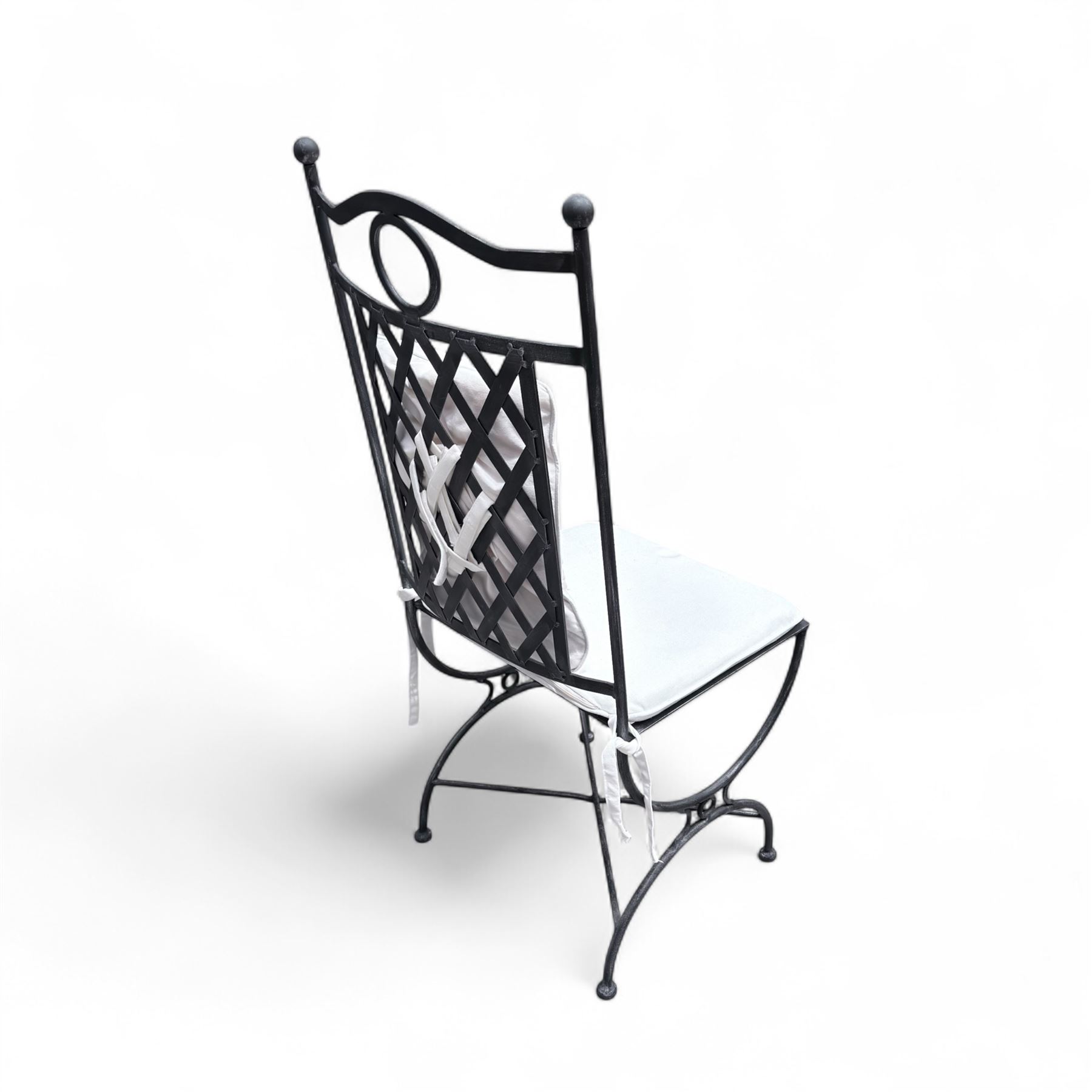 Wrought steel rectangular conservatory dining table, with glass top; and six, four side and two armchairs, with lattice backs and X framed bases, loose cushions