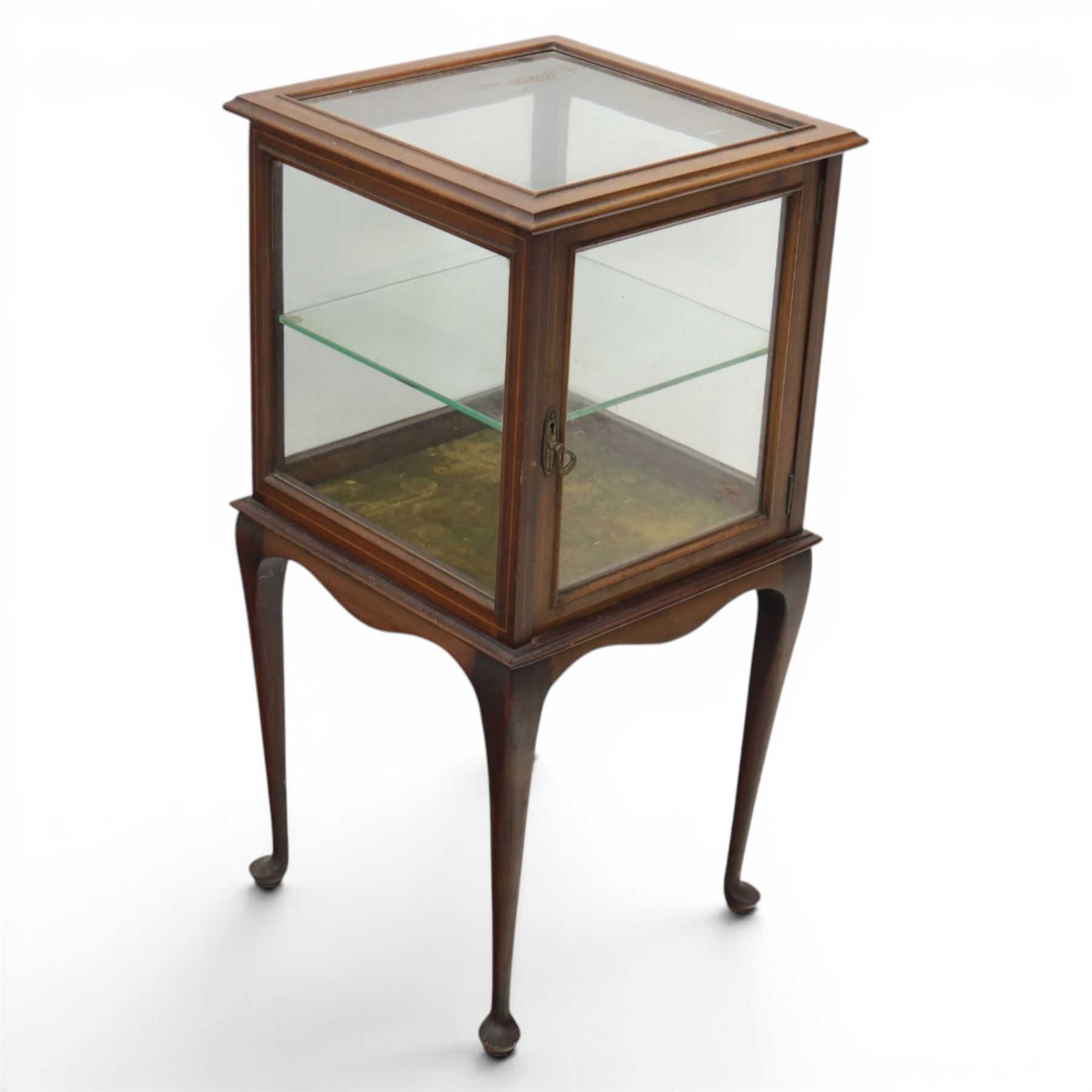 Edwardian bijouterie two tier table, glazed top and sides with inlay surround, glazed door enclosing a single shelf and baized lined interior, raised on cabriole supports