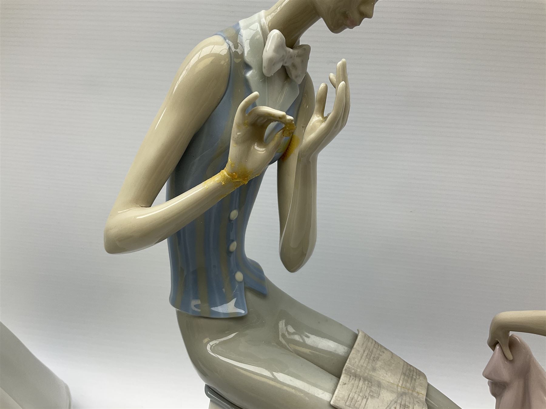 Collection of seven Lladro figures, including Seated ballerina with swan 6204, Childhood Dream 8129, Dancer 5050, reclining clown with ball alongside a selection of other figures. 