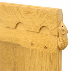 Mouseman - single bed oak headboard, comprising eight vertical fielded panels beneath a shaped and scalloped top rail, carved with the signature mouse motif, by the workshop of Robert Thompson, Kilburn 