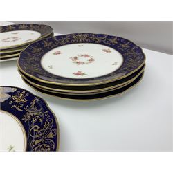 Coalport ten plates and four small serving platters, decorated with floral sprigs within a cobalt blue border, and heightened in gilt with C scrolls and foliate detail
