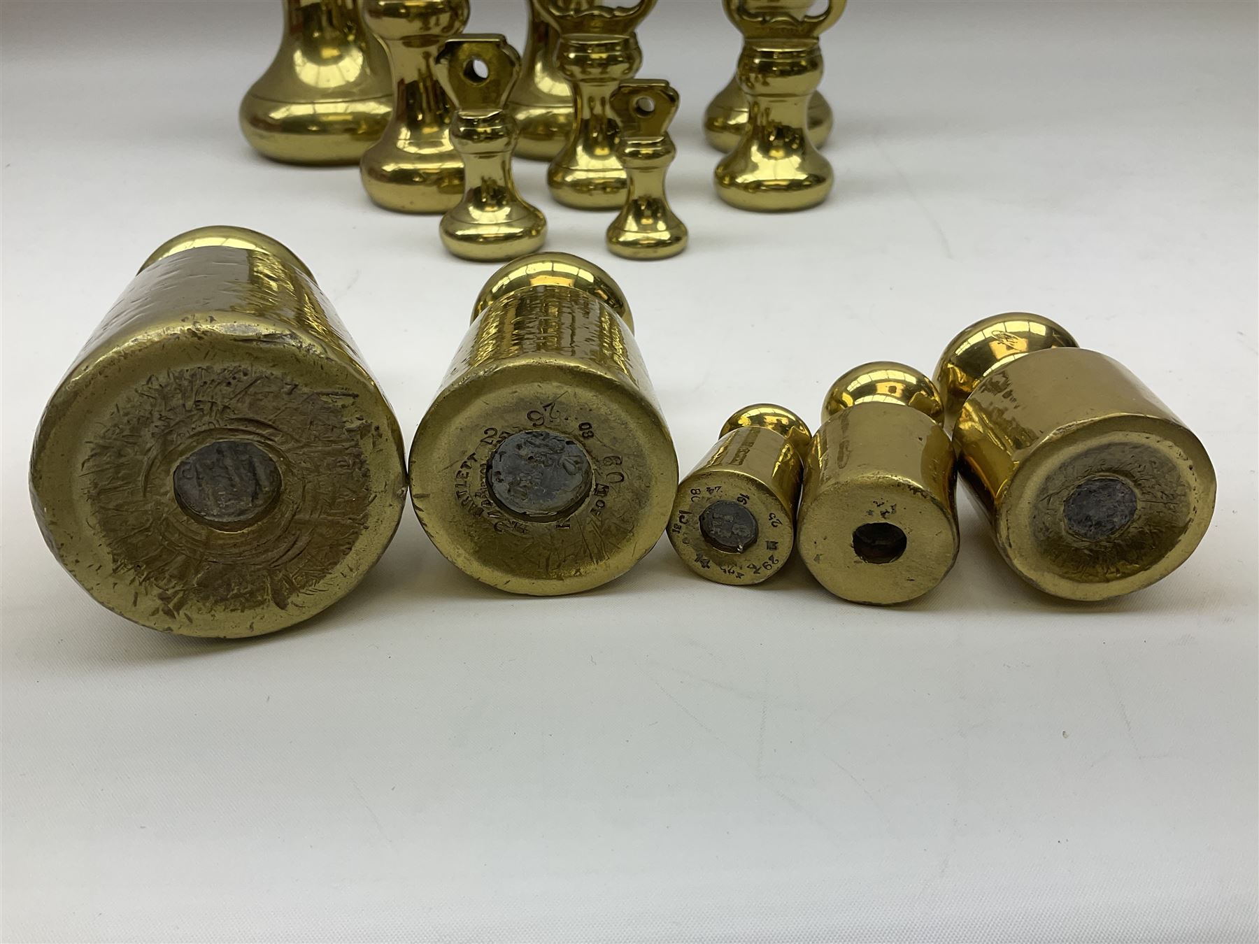 Graduated set of eight brass bell weights, together with a set of five graduating weights (13)