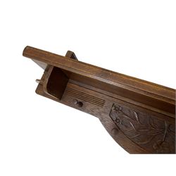 20th century oak wall hanging coat rack, relief carved with extending branches with flower heads, fitted with five turned hooks 