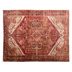 North West Persian Heriz hand-knotted carpet, madder red field, with a large angular stepp...