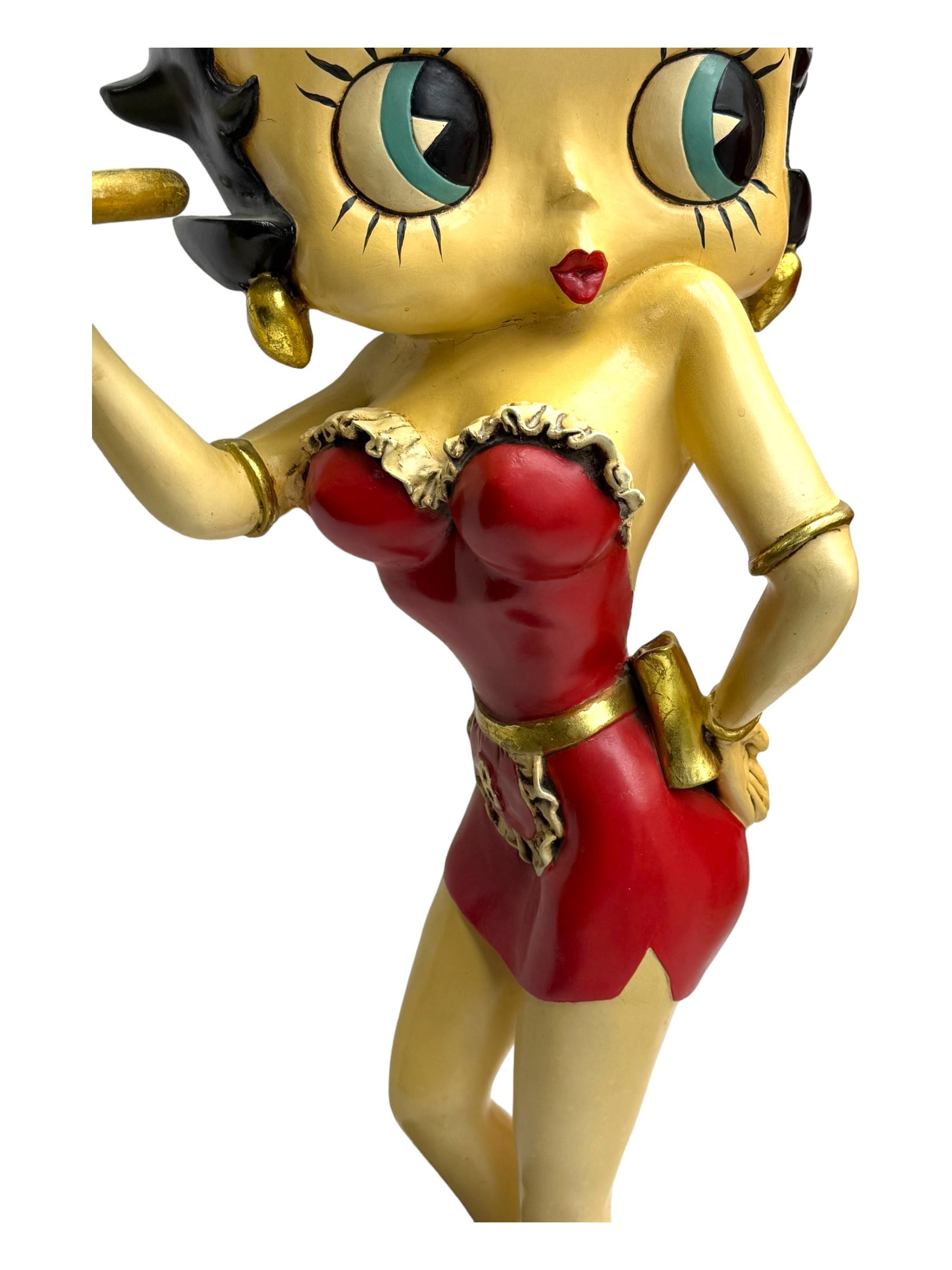 Contemporary Betty Boop waitress figure, modelled standing with one hand holding a circular tray, dressed in a red dress with gold accents, on a black circular base