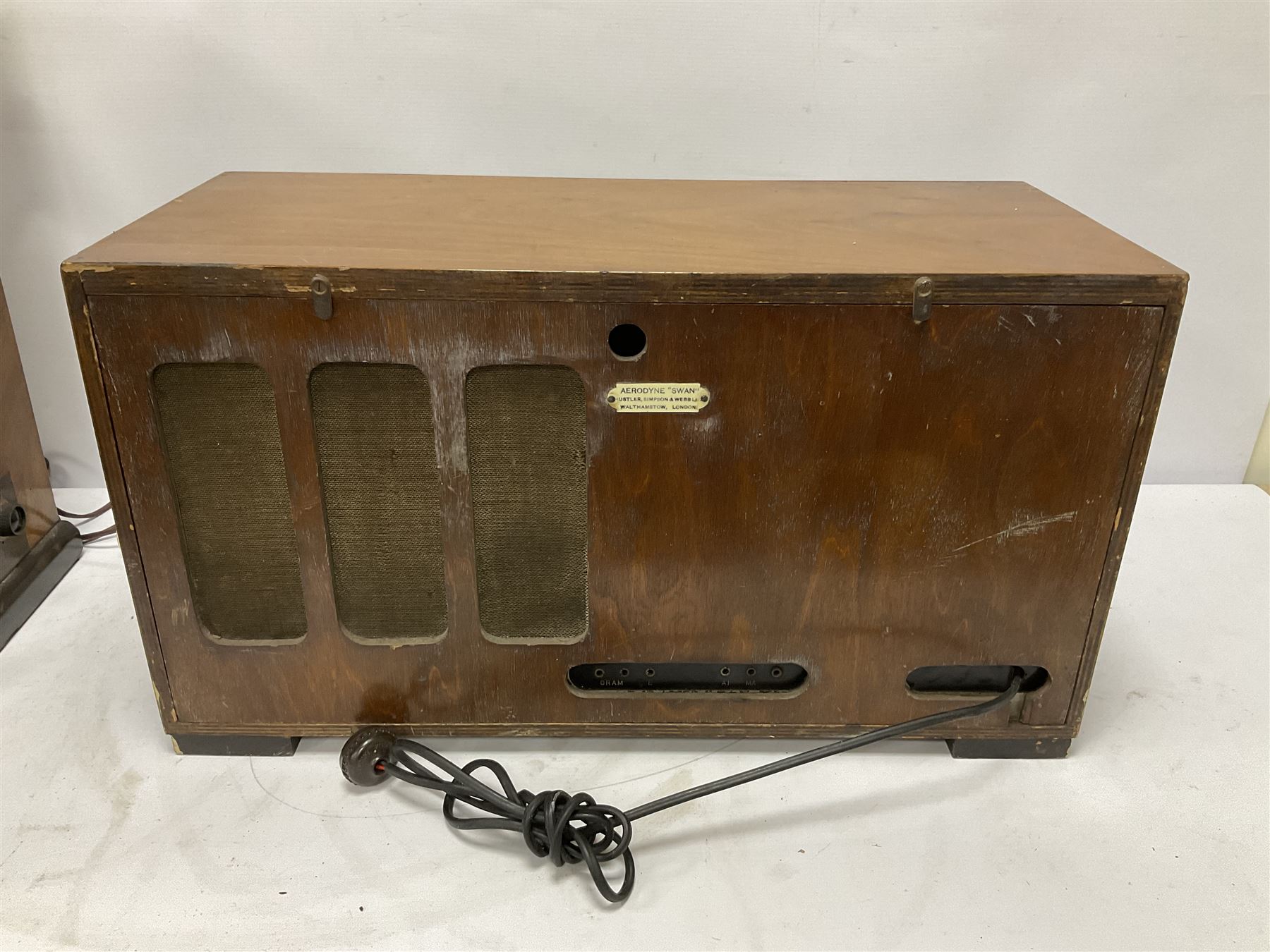 Two 1930s radios, comprising Art Deco Lotus valve example with copper fixtures, H50cm W37cm  together with a Swan Aerodyne example decorated with inlay