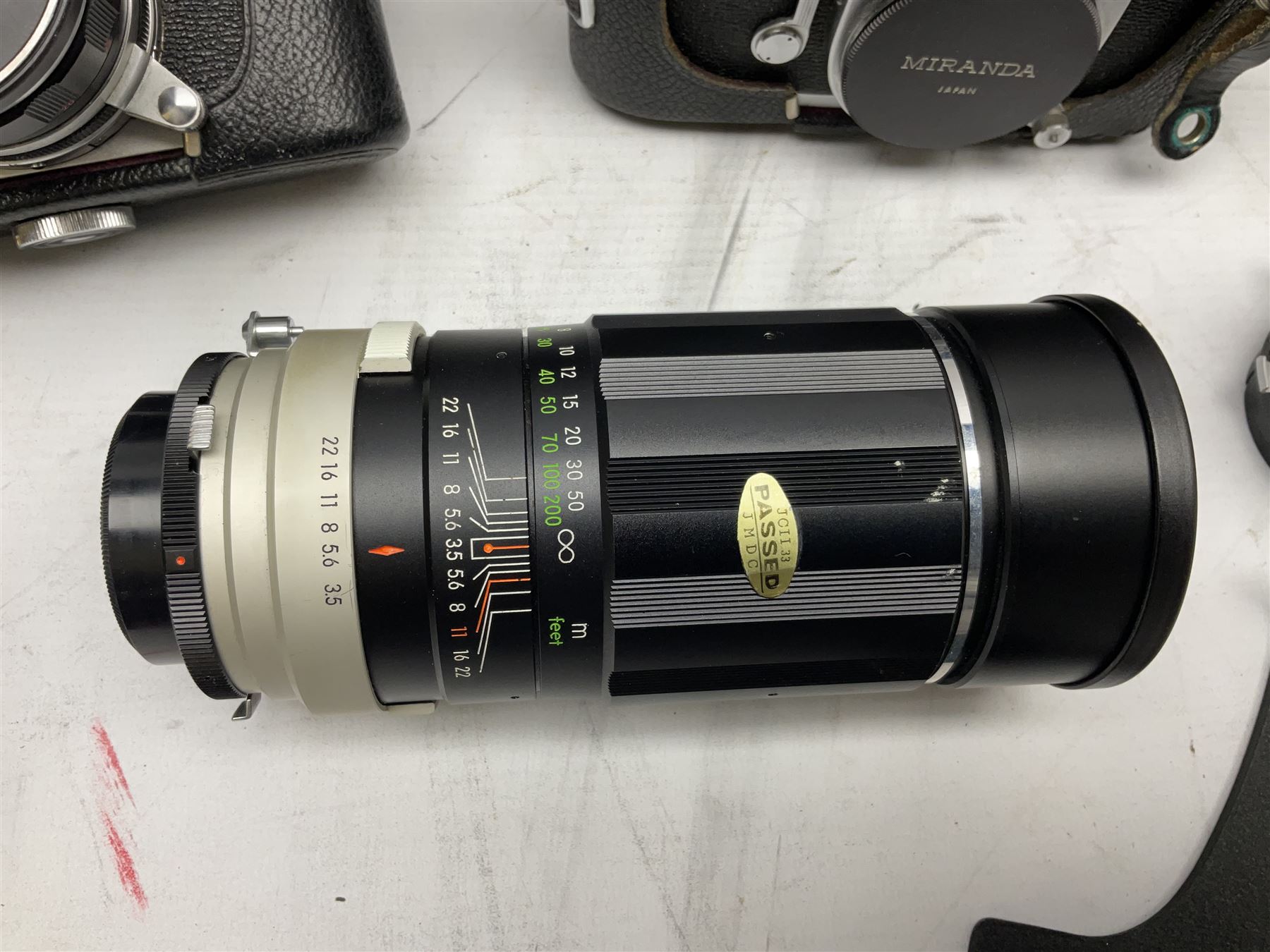 Miranda Sensorex camera body, Miranda Sensorex II camera body with 'Auto Miranda 1:1.8 f-59mm' lens, 'Auto Miranda 1:2.8 f-135mm' lens, 'Auto Miranda 1:3.5 f-200mm' lens, 'Auto Miranda 1:2.8 f-28mm' len, Agfa plate camera with 9cm x 12cm plates and other camera equipment including Miranda camera bag