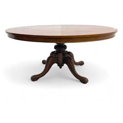 Victorian mahogany breakfast loo table, oval tilt-top on turned pedestal, quatrefoil out-splayed carved supports, scroll carved terminals with brass castors
