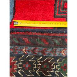 Northwestern Persian Cirjan hand-knotted carpet, madder red field with three linked stepped lozenge medallions in blue, ivory and green, flanked by angular motifs within a dark green border of serrated leaves and rosettes 