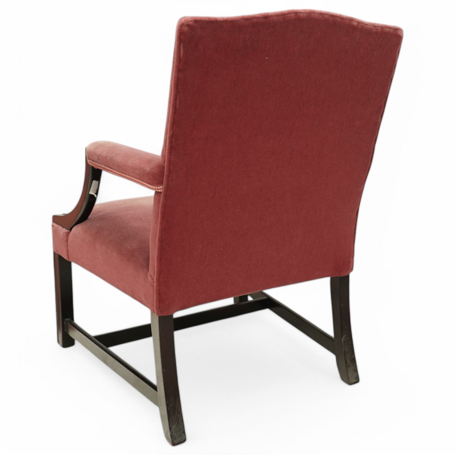 Georgian design mahogany Gainsborough chair, upholstered in pink fabric, curved and moulded arm supports, on moulded square front supports united by H-stretchers 
