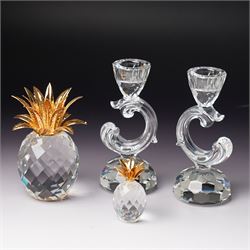 Pair of Swarovski Crystal candlesticks, boxed, together with two paperweights in the form ...