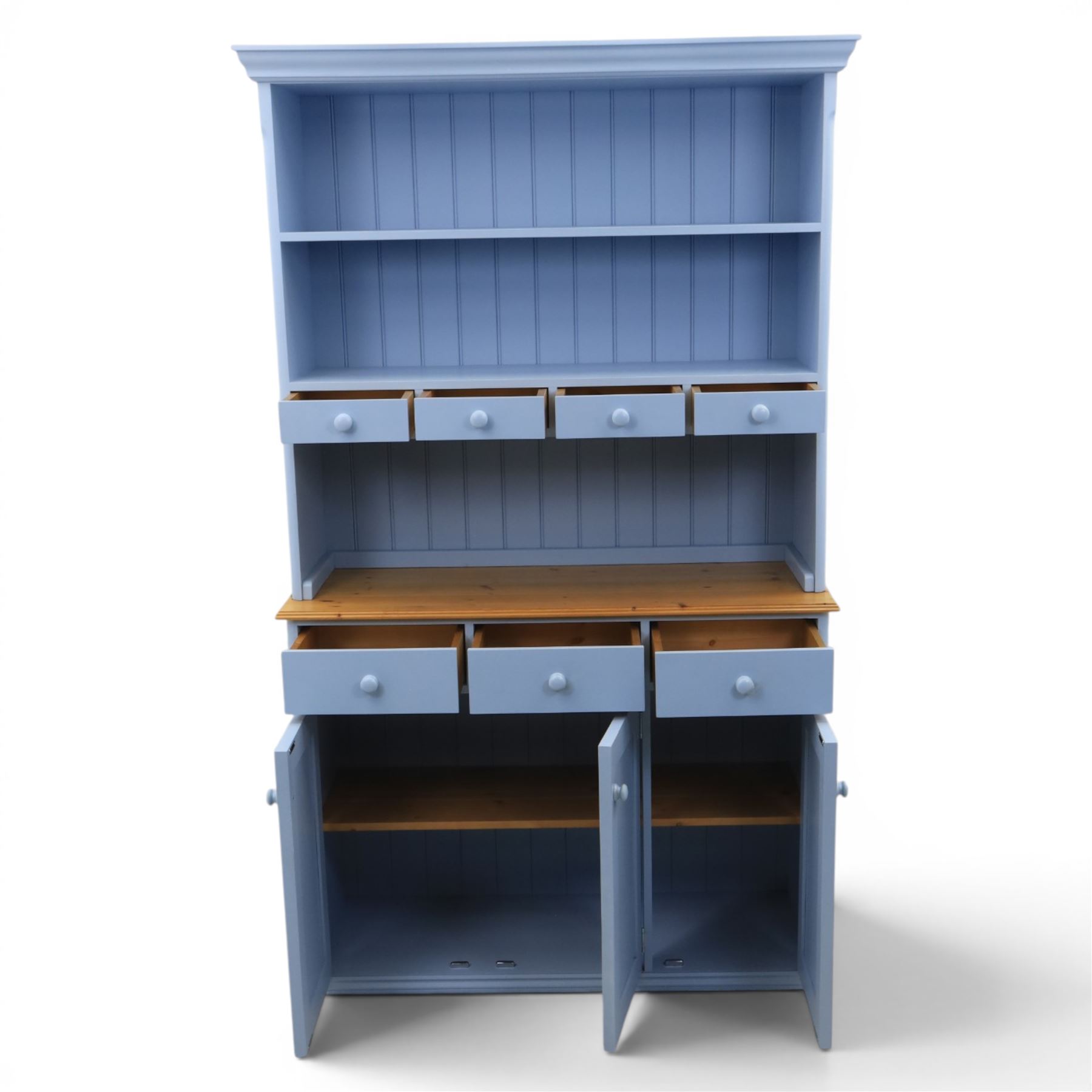 Pine blue painted dresser, upper section with tongue and grove back, two shelves with three short drawers, above a base with soft close short drawers, and three cupboard doors, raised on a moulded plinth base