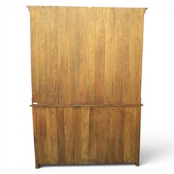 Traditional oak dresser with plate rack in the manner of Titchmarsh & Goodwin, plate rack with projecting cornice and shaped and pierced frieze, tongue and groove back three racks, over seven small spice drawers, the lower section with three short drawers, central bank three of drawers, fielded panelled sides and cupboard doors, raised on stile supports