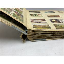 Three albums of cigarette cards including Wills Recruiting Posters, Military Motors and Allied Army Leaders, cricketers etc; another album containing a large quantity of laid-in cigarette cards; and an album of thirty-seven postcards of dogs by Mac (5)