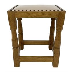 Brian Haw (former Mouseman carver) - Yorkshire oak stool, pale leather upholstered seat with stud band, on octagonal supports joined by plain stretchers