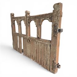 Pair of 19th century weathered wooden ecclesiastical church gates, the cresting rail over four pierced arches with slatted lower section, fitted with heavy cast iron hinges, latch and fittings