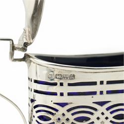 Silver three piece oval condiment set with engraved decoration Birmingham 1961, pierced silver mustard pot Chester 1901, silver pepperette and silver mounted glass salt