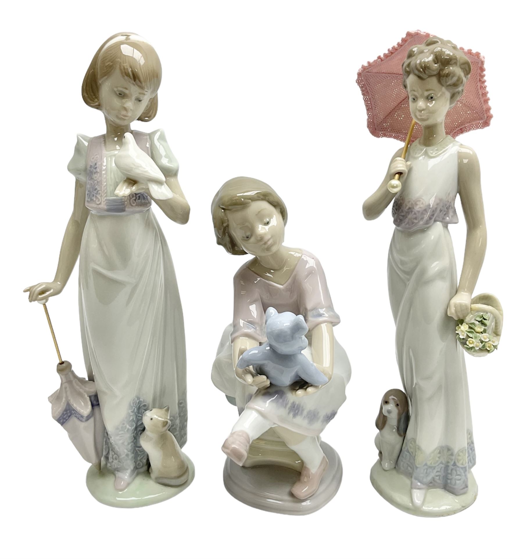 Three Lladro figures, comprising Garden Classic, signed no 7617, Summer Stroll no 7611 and Best Friend no 7620, all with original boxes, largest example H24cm 