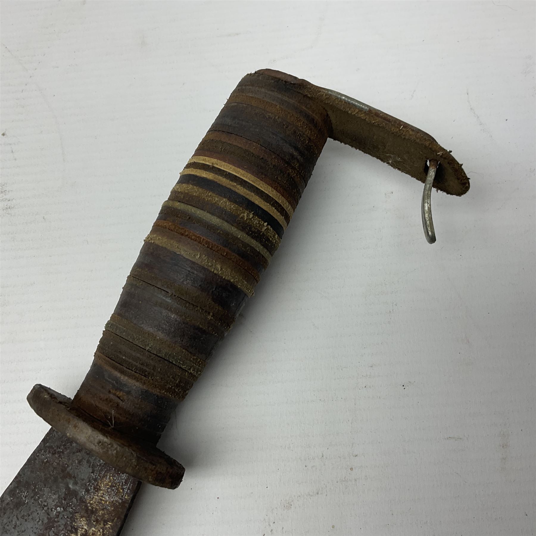 Moroccan jambiya dagger with 24.5cm plain curved blade stamped LONDON to the ricasso area, the hilt and scabbard overlaid with plain sheet brass to the back and ornate silver coloured metal to the front; waisted grip and arched pommel; two pyramid mounts to the scabbard L41cm overall; large billhook with curving blade and stacked leather washer grip; and a reproduction halberd blade (3)