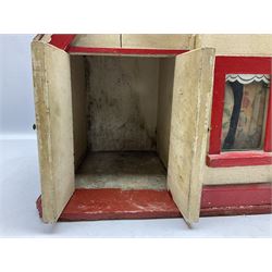 1960s scratch-built wooden doll's house as a red and white painted two-storey house with half-timbered gable and integral garage with opening doors, the hinged front elevation opening to reveal two rooms with glazed windows W47cm H58cm D28cm