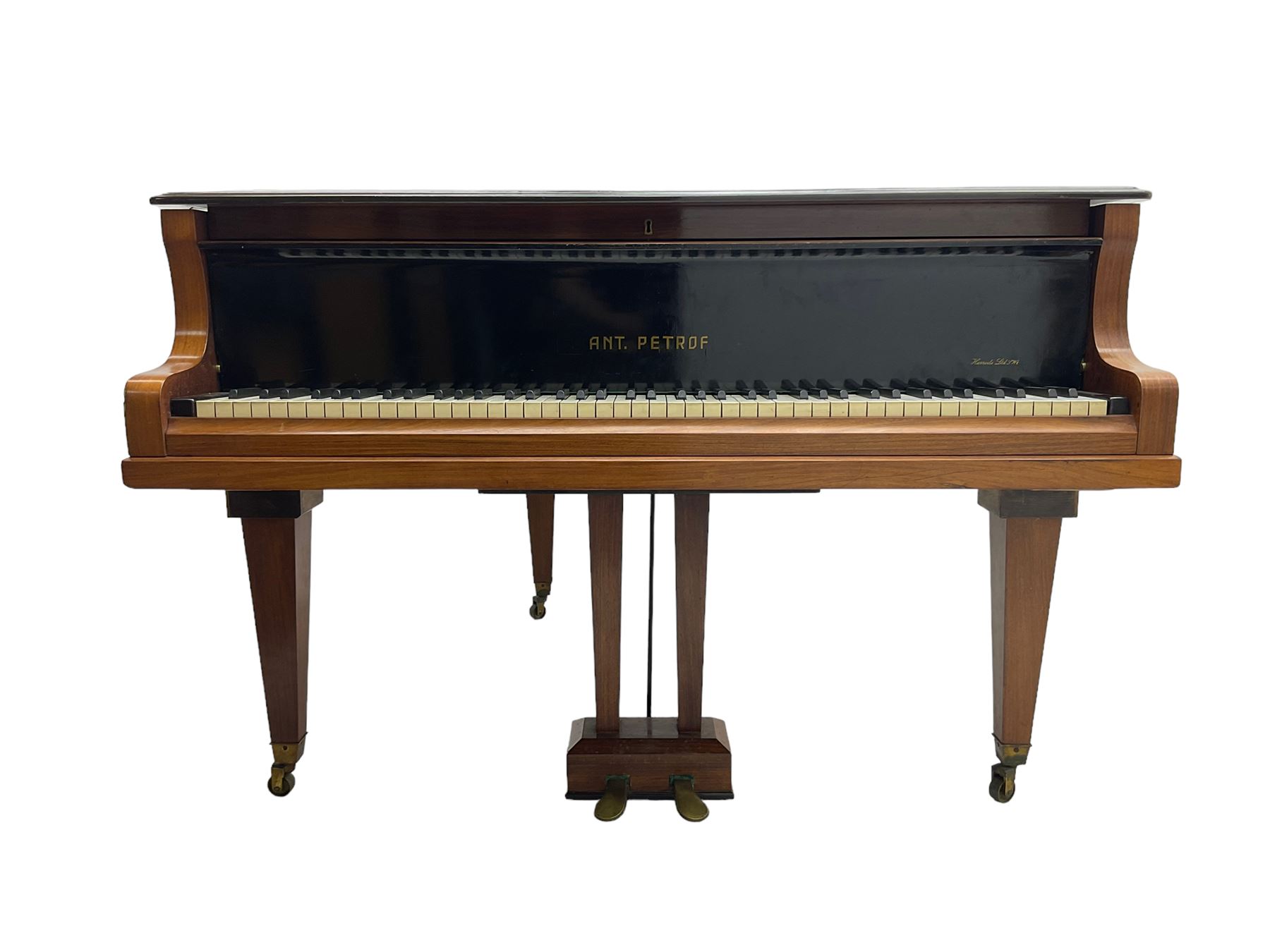  Antonin Petrof - Walnut overstrung baby grand piano, 7 0catve 85 key compass with original strings, tuning pins, damper felts and hammer heads, with roller keyboard action and iron frame, sustaining and una-corda pedals, sliding open lattice music desk, supported on square tapering legs with brass cups and castors, with inner ebonised key fall and ivorine label inscribed 'Supplied by Harrods, London'.
