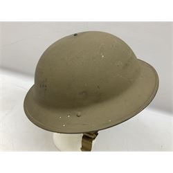 WW2 Home Front rough textured steel helmet dated 1941, drilled with three holes to signify not suitable for combat use, with original liner 