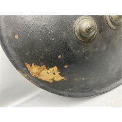 Indian black lacquered hide shield/dhal, of circular convex form with strongly outward-turned brim, fitted at its centre with four metal bosses, each of hemispherical form, with traces of silvered foliate decoration, the bosses corresponding on the inside with four iron rings for enarmes D49cm