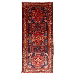 North West Persian runner, the indigo field decorated with three stepped cruciform medalli...