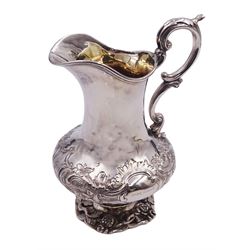 Victorian silver cream jug, of bellied form with embossed foliate and C scroll decoration and acanthus capped scroll handle, upon a cast foliate detailed foot, hallmarked Benjamin Smith III, London 1842, including handle H16.5cm, approximate weight 9.08 ozt (282.7 grams)