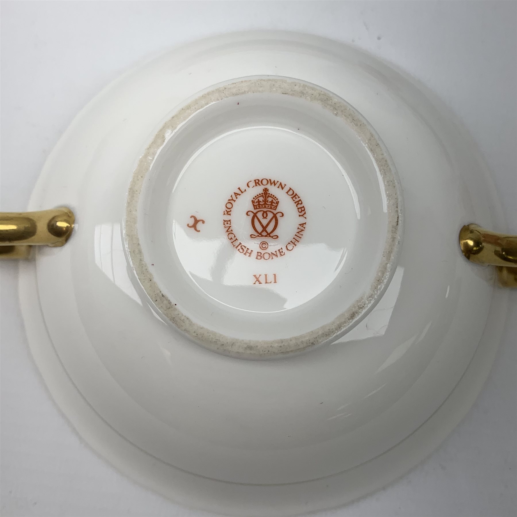 A selection of assorted Crown Derby, comprising three Mikado pattern dessert plates, D21.5cm, a Blue Aves pattern dish, a small Red Aves beaker, a Gold and Red Aves twin handled soup bowl with heraldic border, a small Royal Antoinette pattern plate, small commemorative dish, and a paperweight modelled in the form of a teddy bear (lacking stopper). 