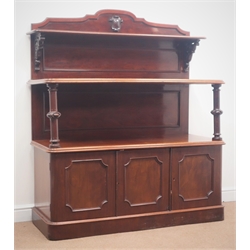  Victorian mahogany three tier buffet sideboard, raised shaped back with carved shield, turned support columns, three panelled cupboard doors enclosing single drawer, plinth base, W140cm, H162cm, D53cm  