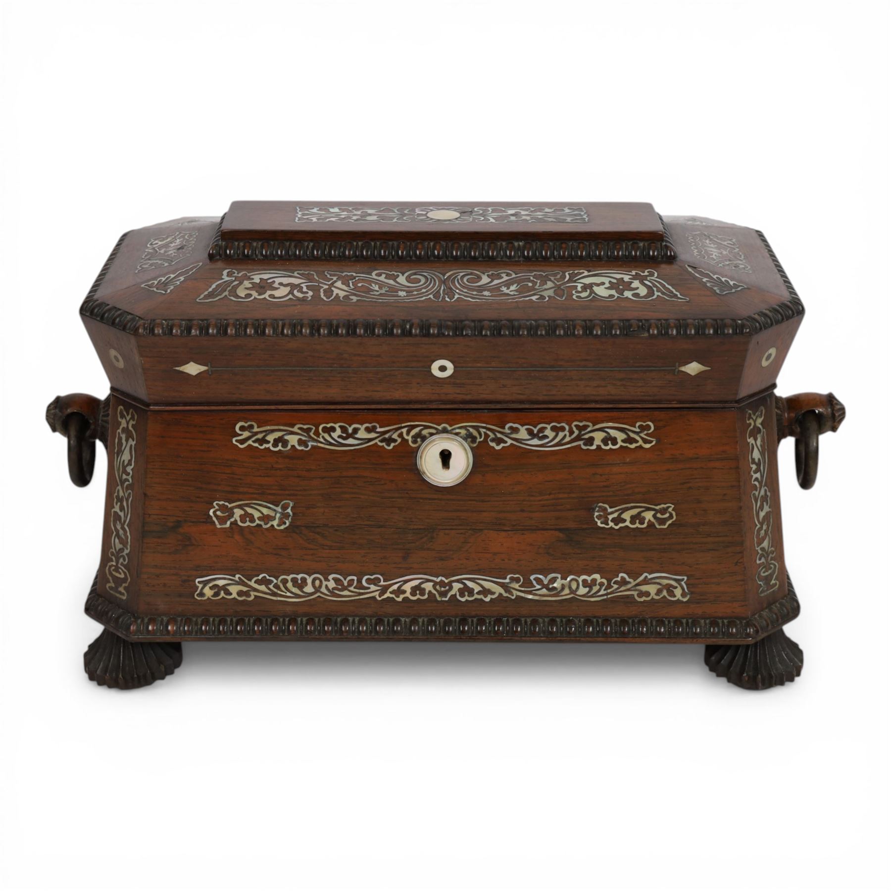 Tea caddy of sarcophagus form, inlaid with mother of pearl decoration,  the hinged lid opening to reveal two covered compartments, H24cm 