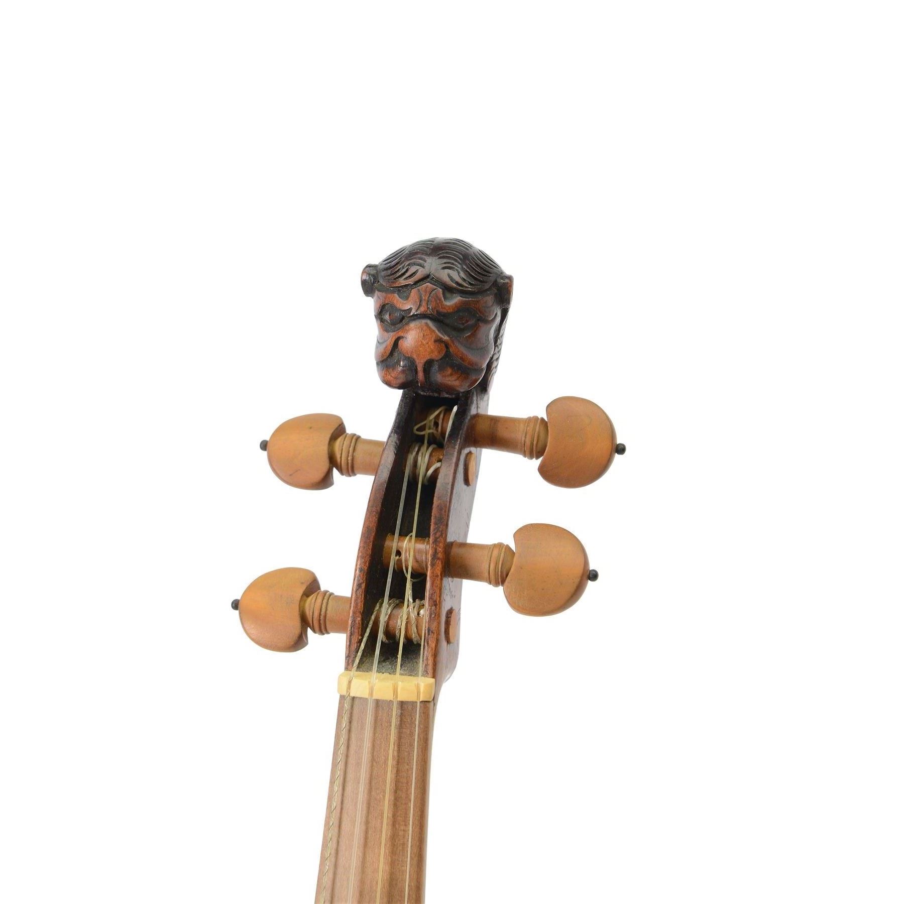 Violin - with a carved Lions head scroll and period style replacement fingerboard and fittings, in a later hard case, no bow, possibly from Germany or Bohemia.
Thought to have originated in the Tyrol region between Austria and Germany this design of scroll was very popular from the late 17th century onwards and well into the 19th century.