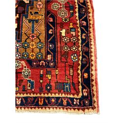 Persian Nahawand rug, central medallion in a field decorated with plant motifs, the guarded border decorated with flower heads and geometric motifs