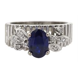 14ct white gold open work and leaf design ring, set with a singe oval sapphire and round diamonds