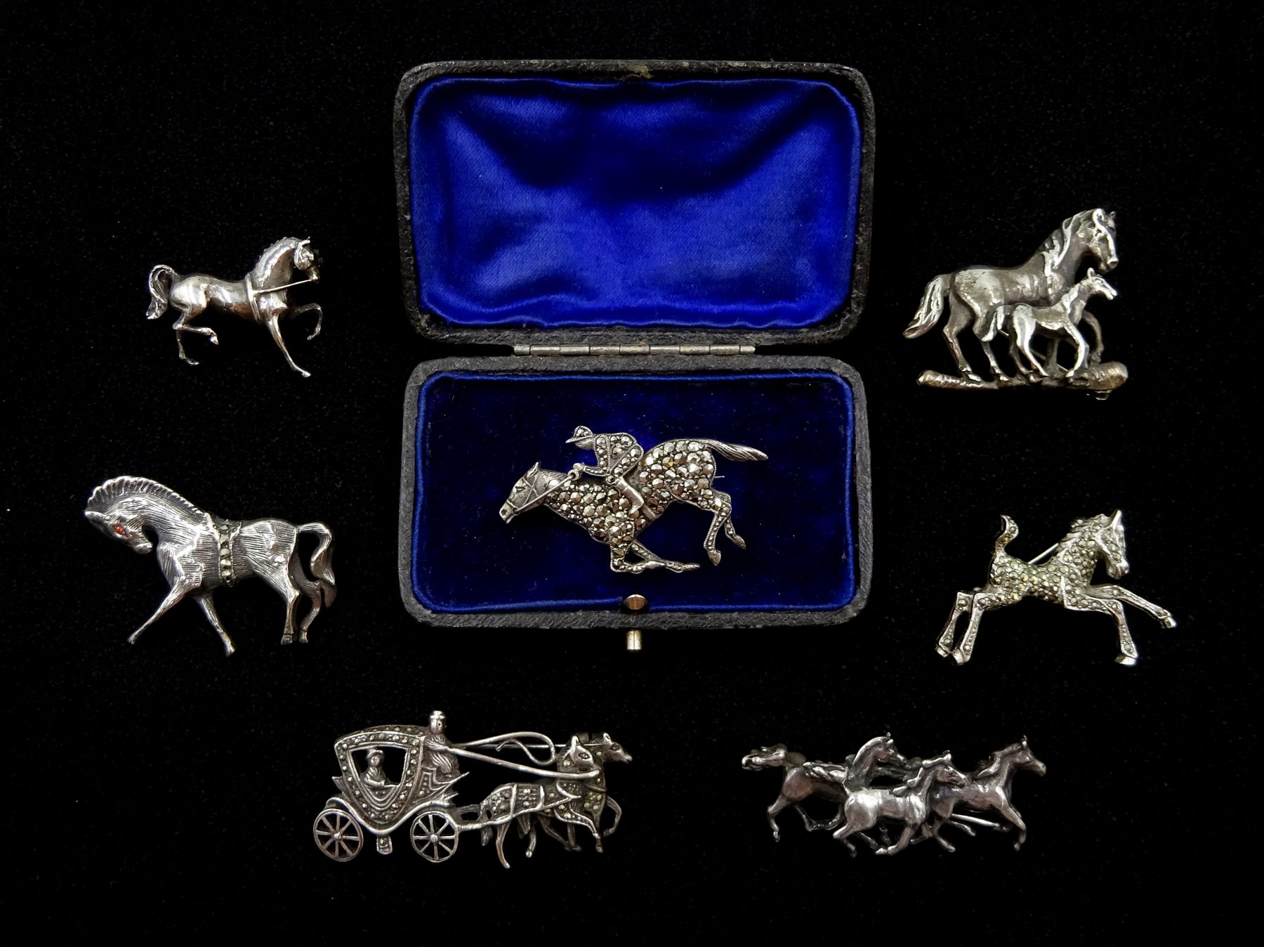Silver and marcasite racehorse brooch, silver trotting horse makers mark HG, London 1995, four other silver horse brooches, all stamped and one other