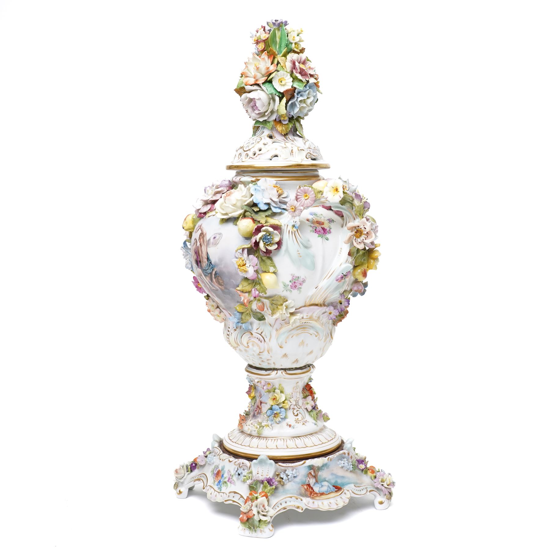 Pair of 19th century Potschappel porcelain two handled vases with covers and stands, painted with scenes of classical figures including Dionysus and Ariadne and with profusely applied flower heads on a scrolling field with gilt highlights H49cm (2)