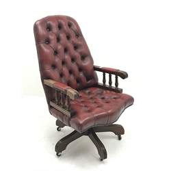 Swivel reclining desk chair upholstered in deep buttoned oxblood leather, W60cm