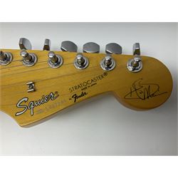 Japanese Squier Fender 'Hank Marvin' Stratocaster electric guitar, c1992, in Fiesta red with tremolo arm and facsimile signature decal; serial no.L037281, L98cm; in hard carrying case.