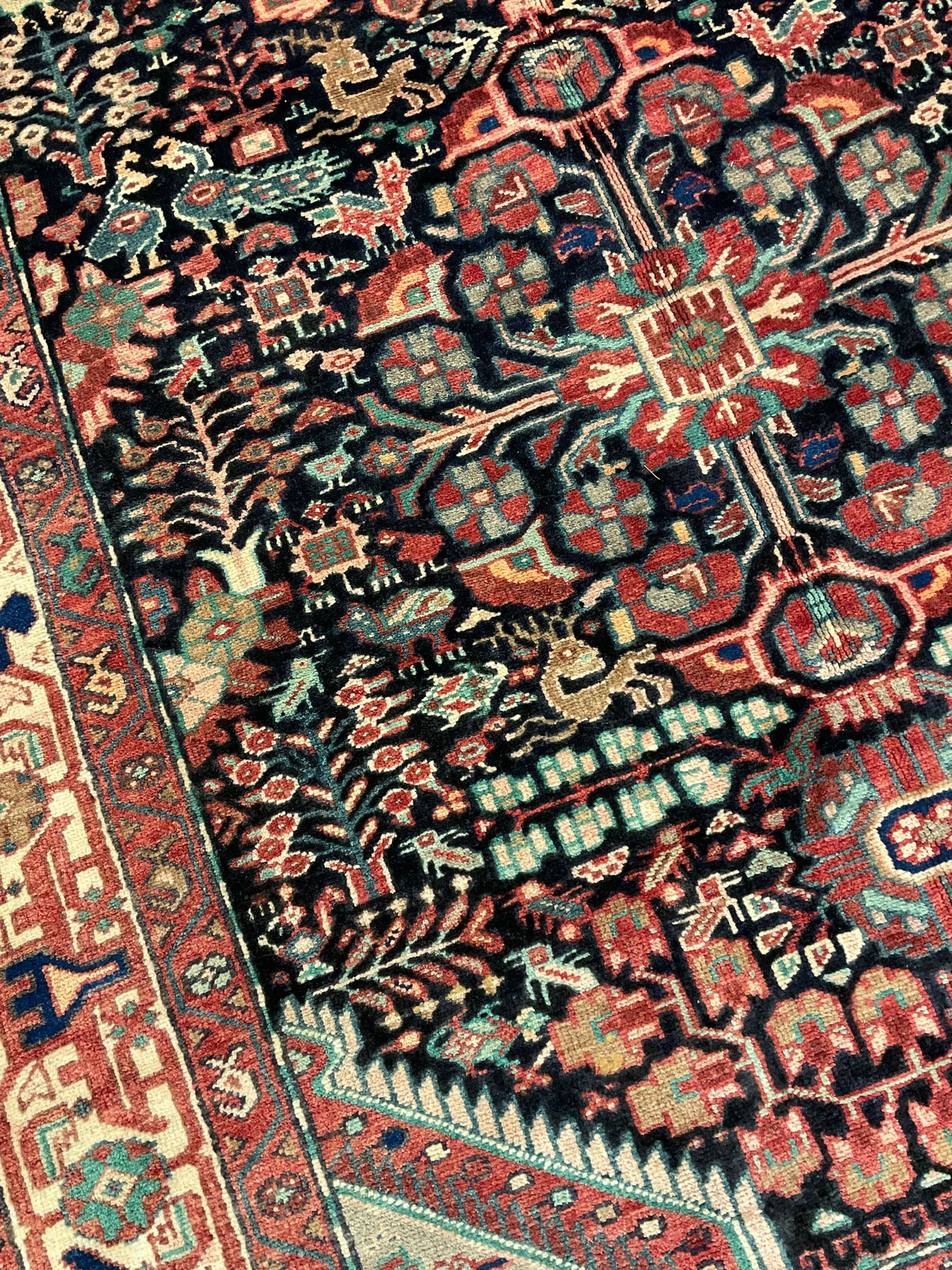 Persian Malayer rug, the field decorated with tree of life, floral, animal and bird motifs, surrounded by three band border with geometric design