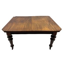 Late Victorian mahogany telescopic extending dining table, canted rectangular top with two additional leaves, turned tapering and fluted supports, brass and ceramic castors 